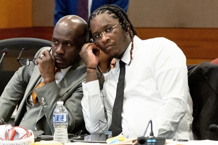 Atlanta rapper Young Thug listens in on a bench meeting
